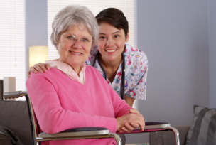 elderly woman and nurse smiling